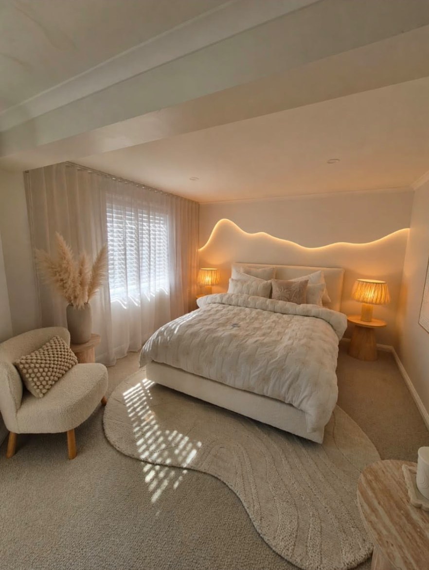 Finished bedroom with curved LED-lit feature wall behind the bed