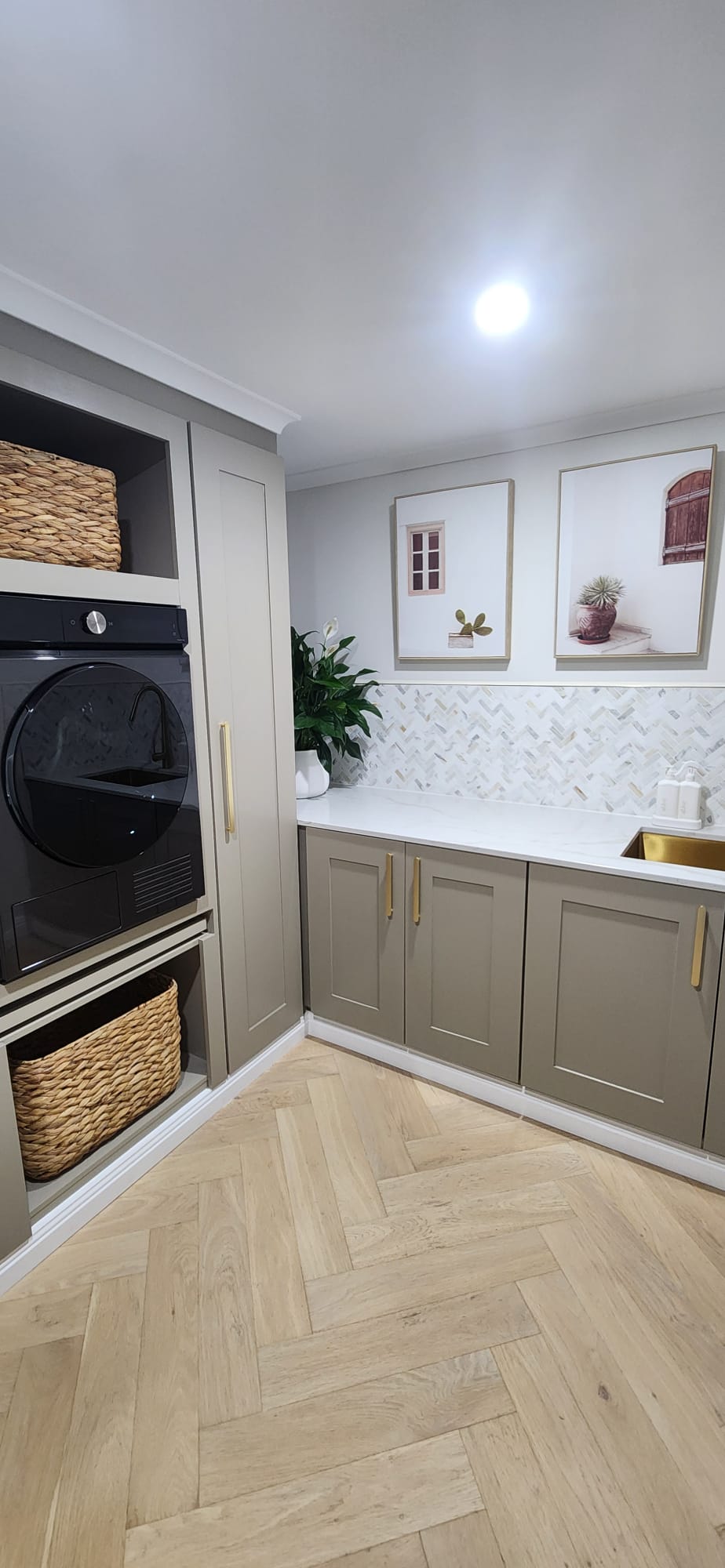 Laundry corner with tall cabinet, built-in dryer and stone benchtop