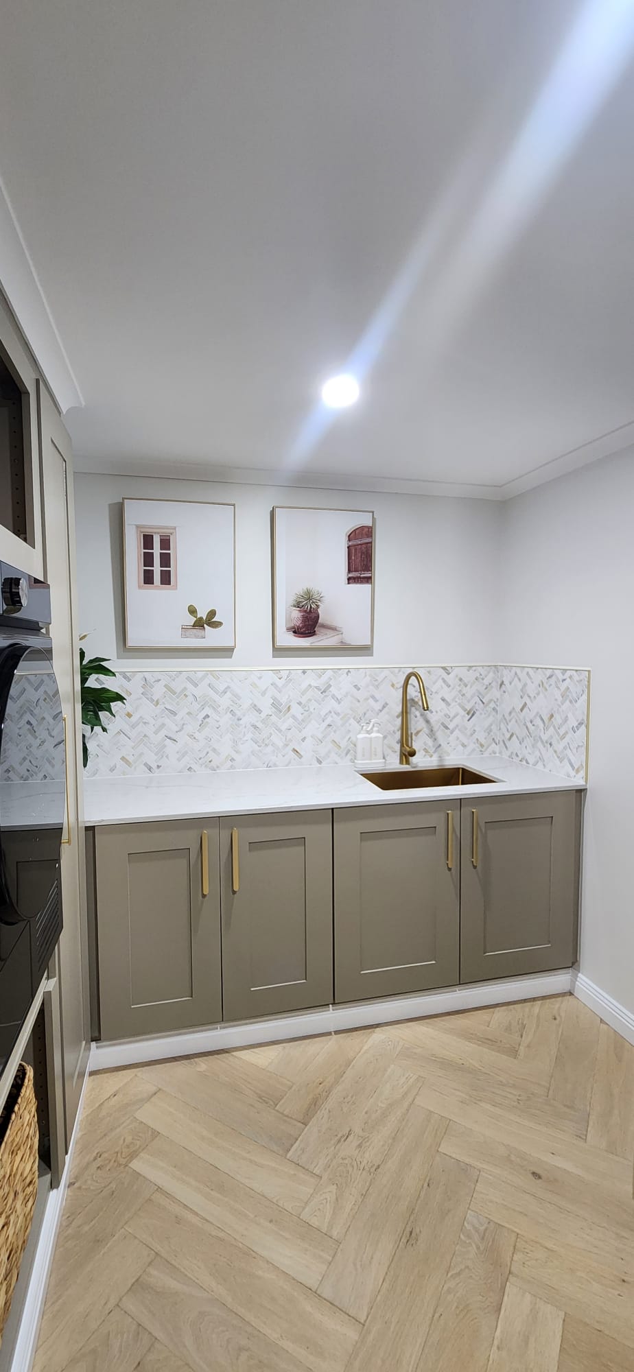 Laundry bench with brass sink, herringbone mosaic splashback and shaker cabinets